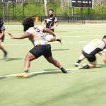 rugby player spinning out of a tackle with a wide stance