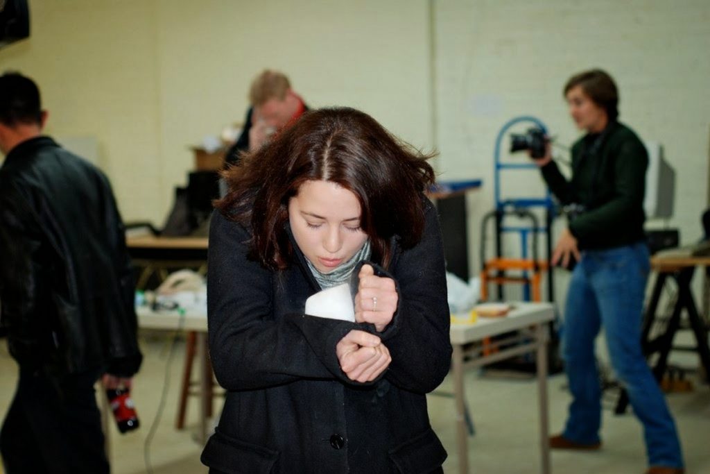 Woman holding dry ice with her coat sleeves