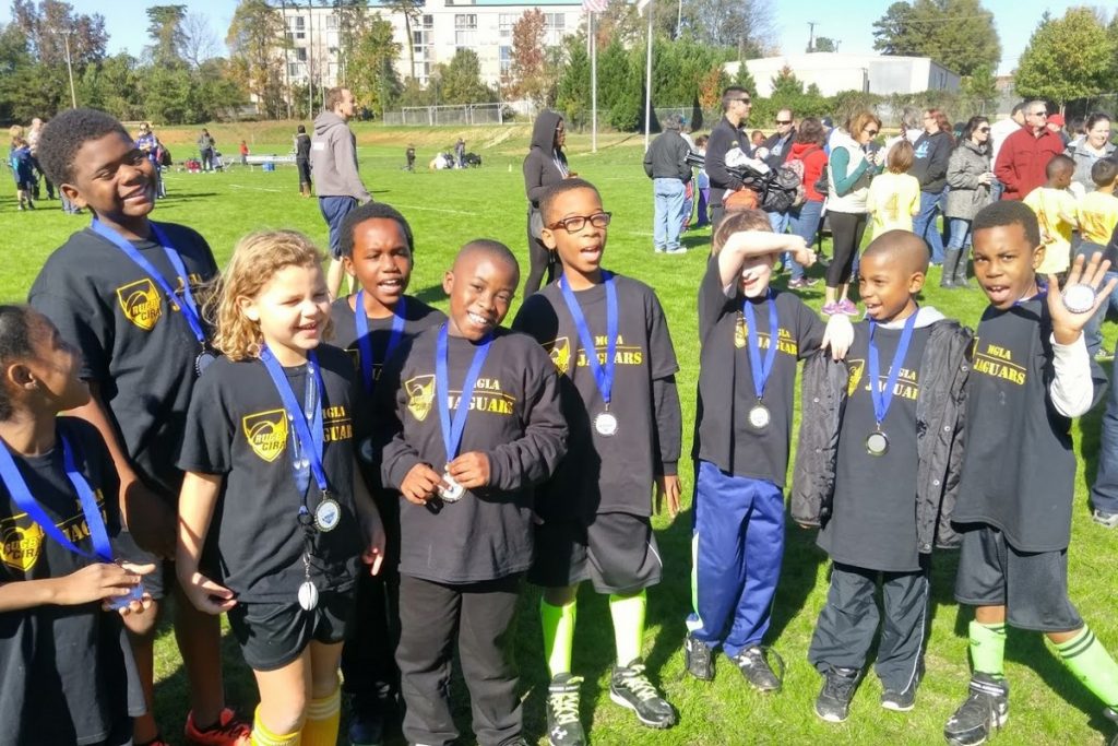 Elementary school kids wearing rugby tournament medals