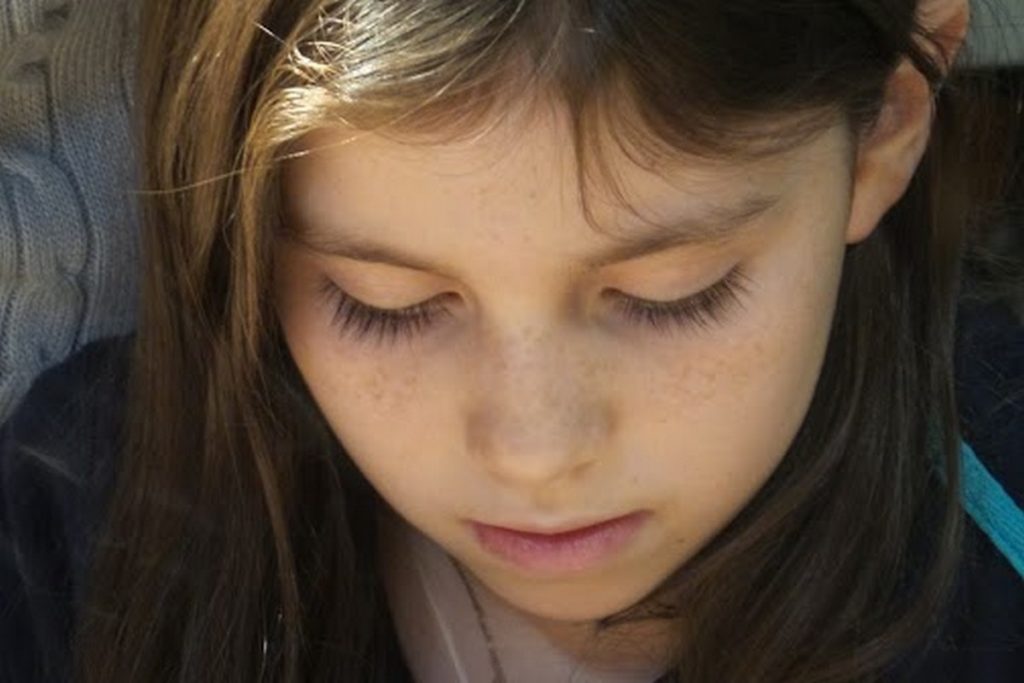 close up of a girl looking intently down