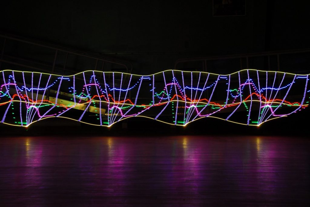 multi colored lights in a dark room as if plotted on a graph...but as a long exposure photo