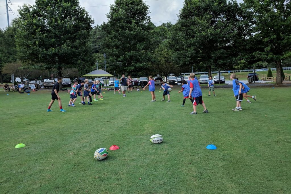 Kids playing rugby in the park