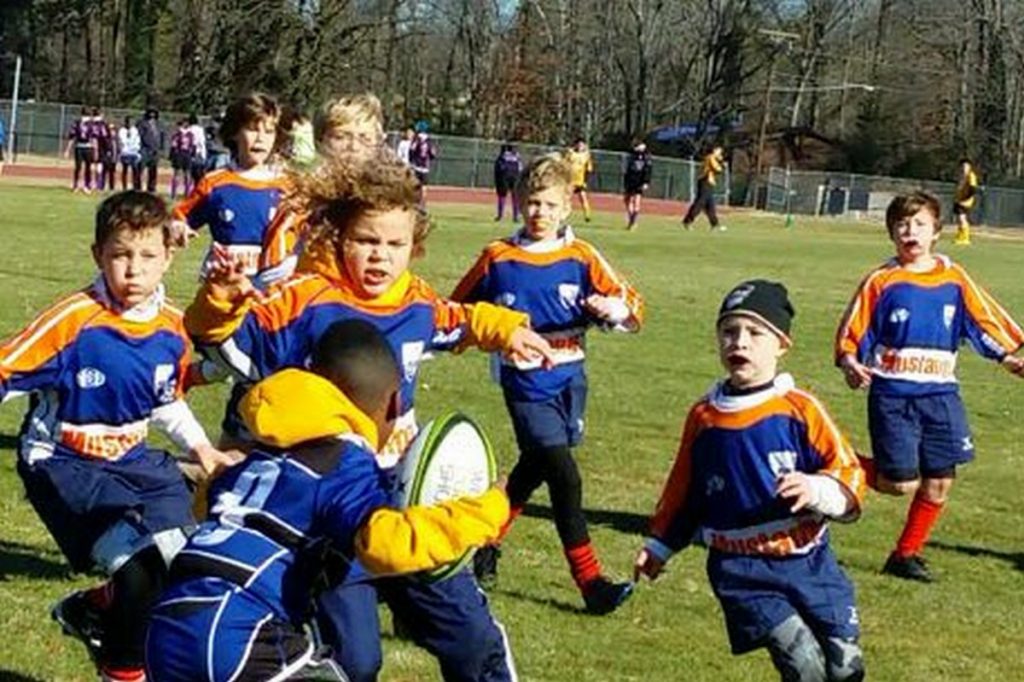 Kids rugby team converges on single oppoent