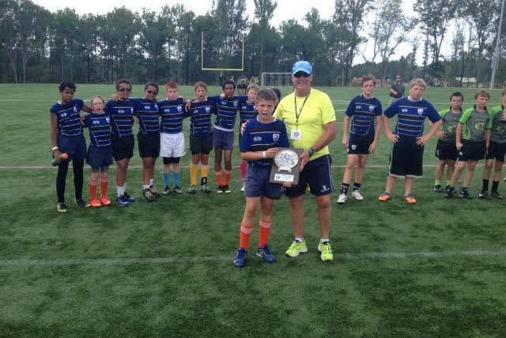 Rugby player holds trophy