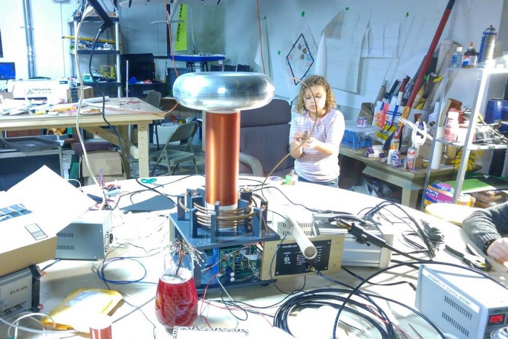 Young girl in a messy makerspace