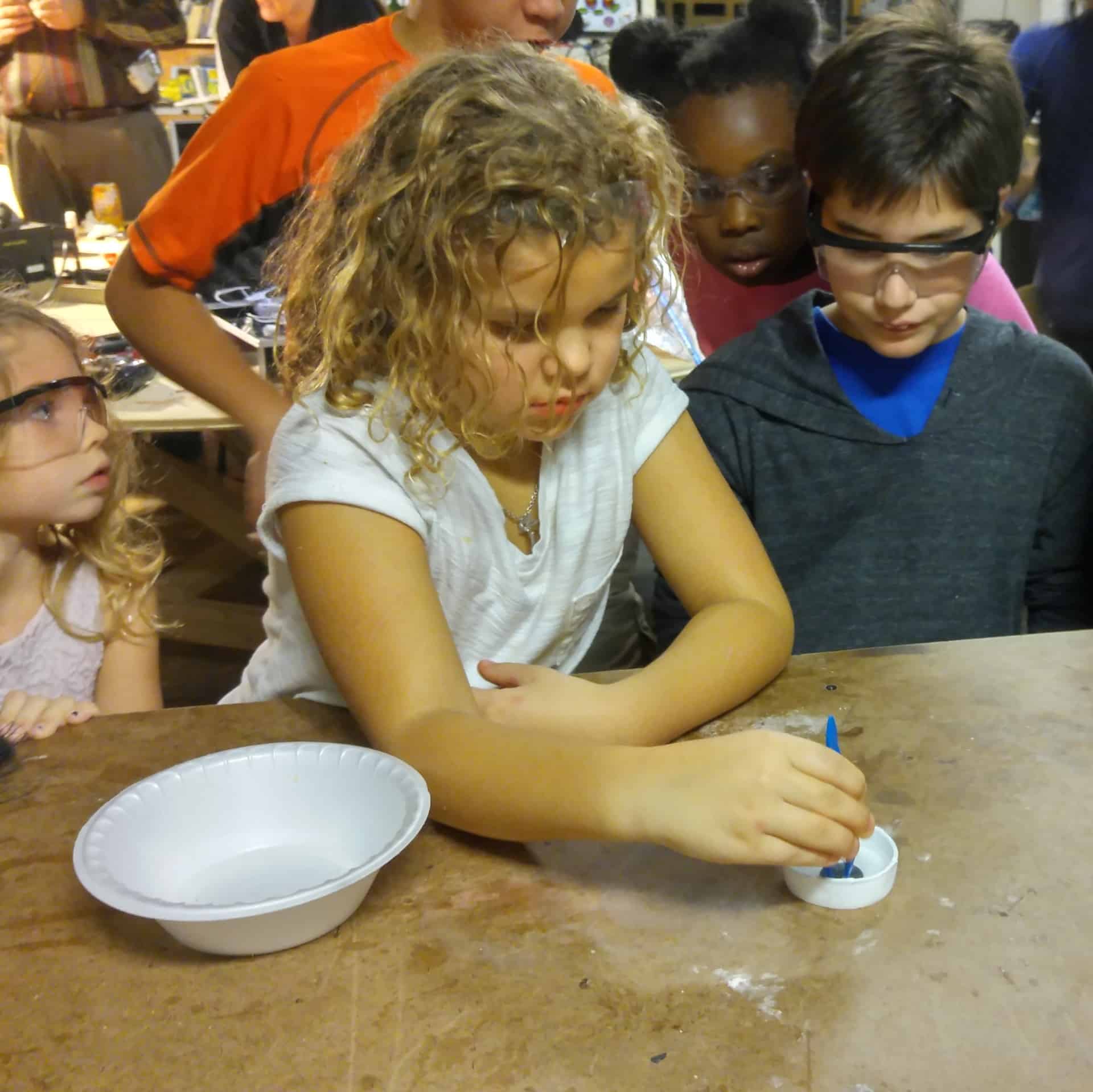 kids playing with liquid nitrogen, super conductor, and magnets